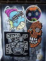Street_art_stickers_by_Rx_Skulls,_Nvrasir,_ShallowLagoon_and_Dark_Evil_on_a_sign_in_Brick_Lane...jpg